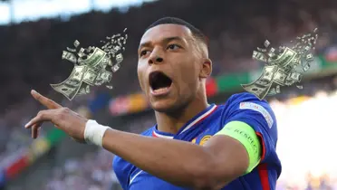 Kylian Mbappé shouts as he celebrates his goal in the EUROS while flying money is next to him. (Source: EURO 2024 X)